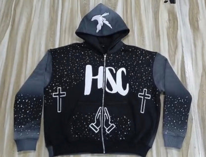 Black hoodie with white text and symbols on a neutral background